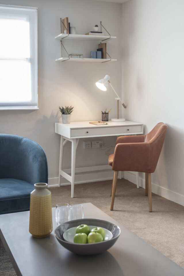 Counselling room with desk and pastel colour scheme